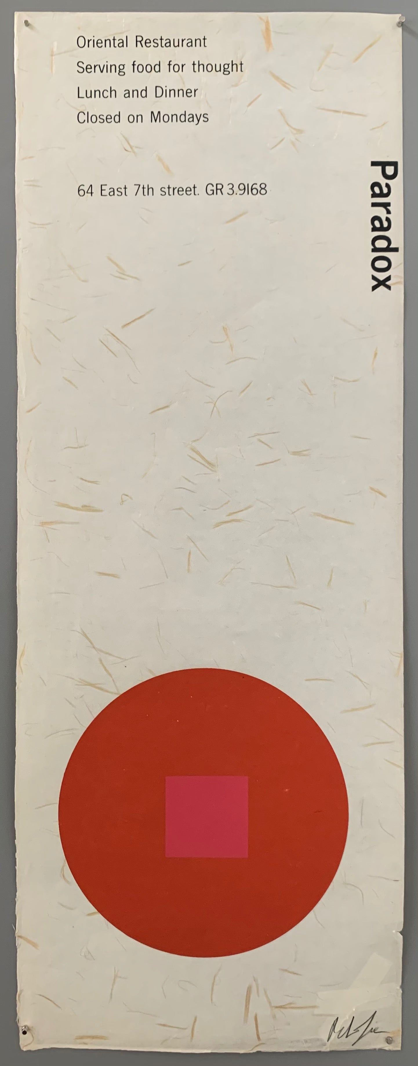 A red circle with a pink square on light brown textured paper.
