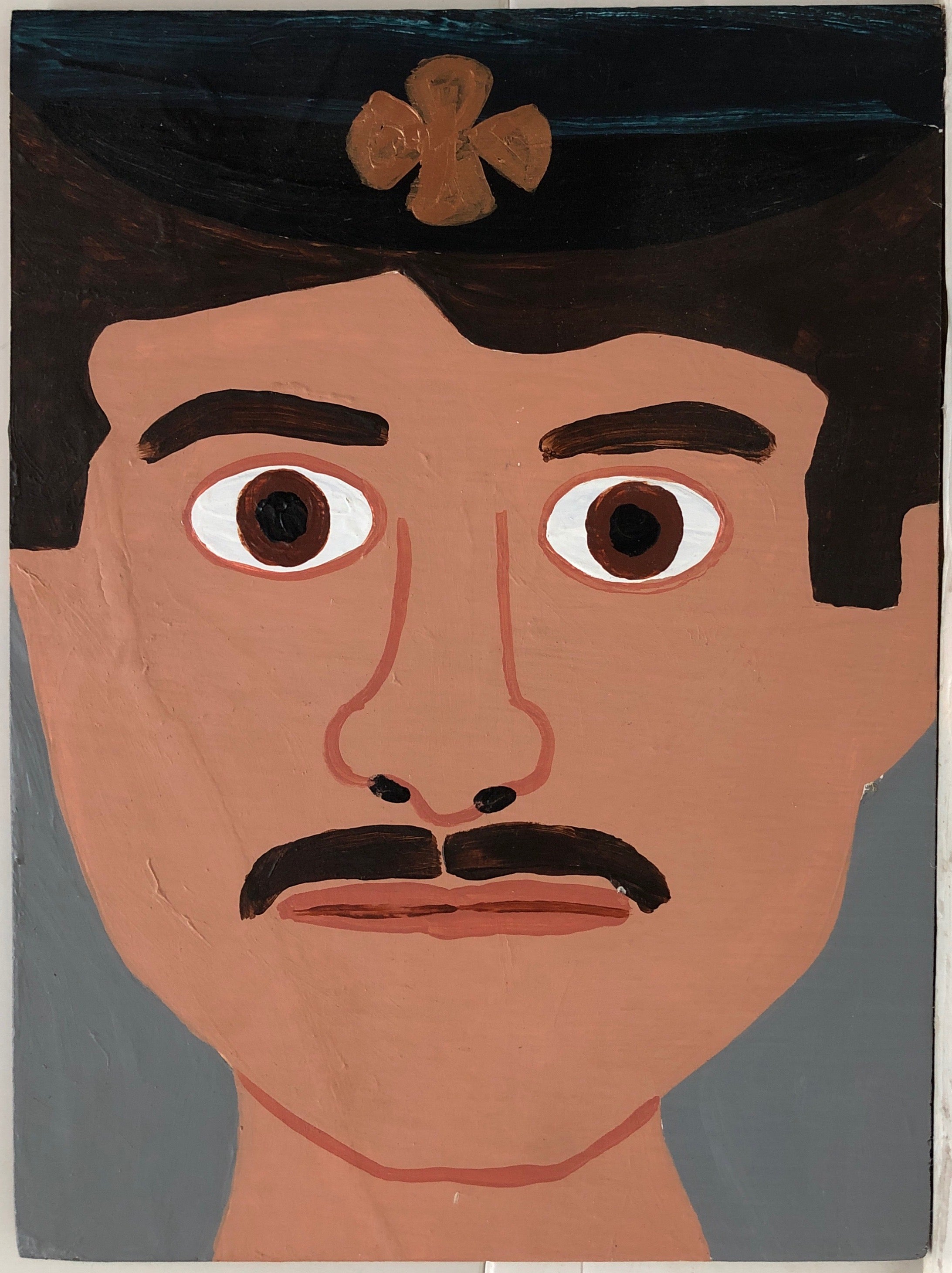 Portrait of John Bergin in a navy firefighter's hat.