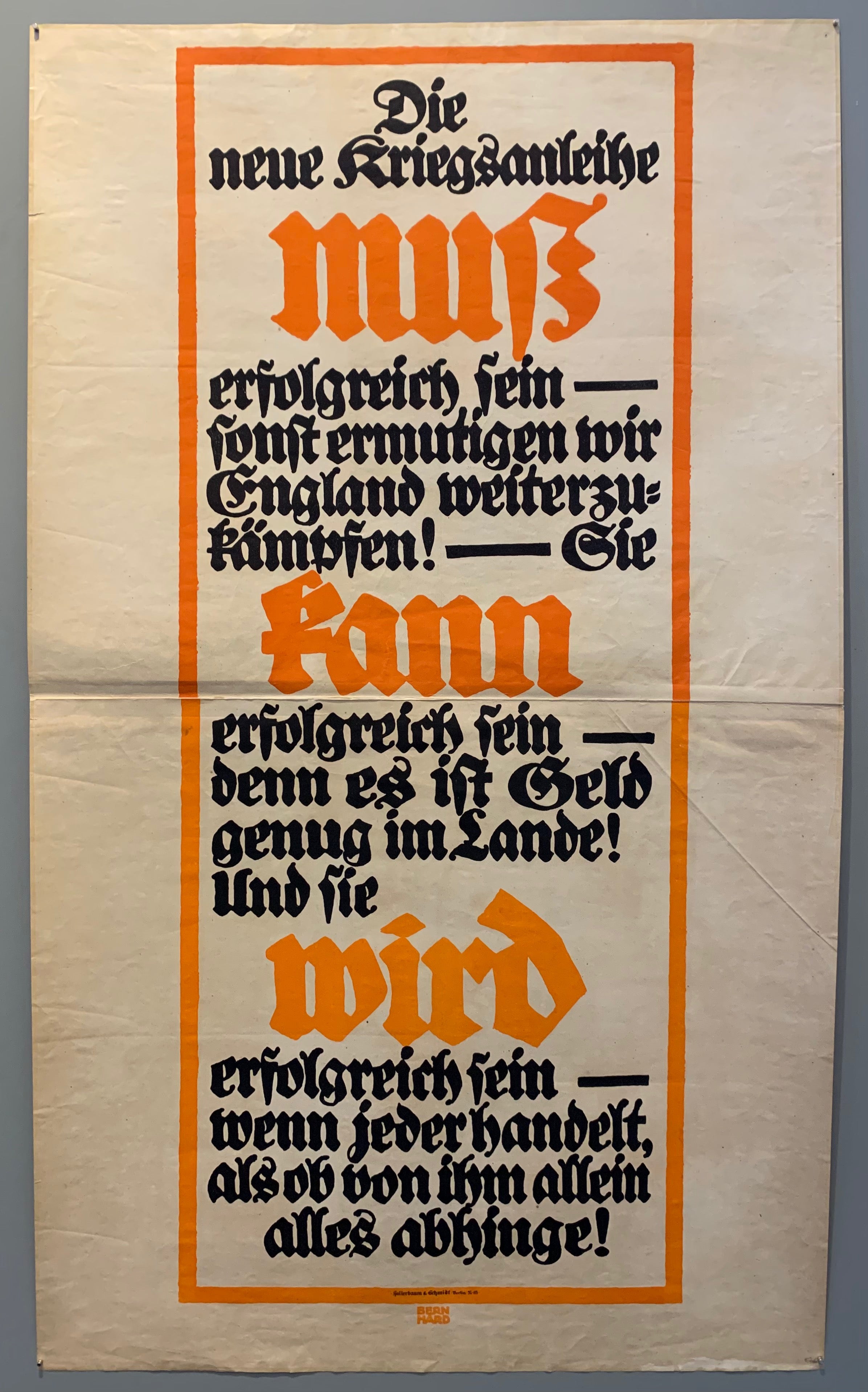 Poster in a Fraktur typeface. A red bow down the middle of the poster with black and red text inside.