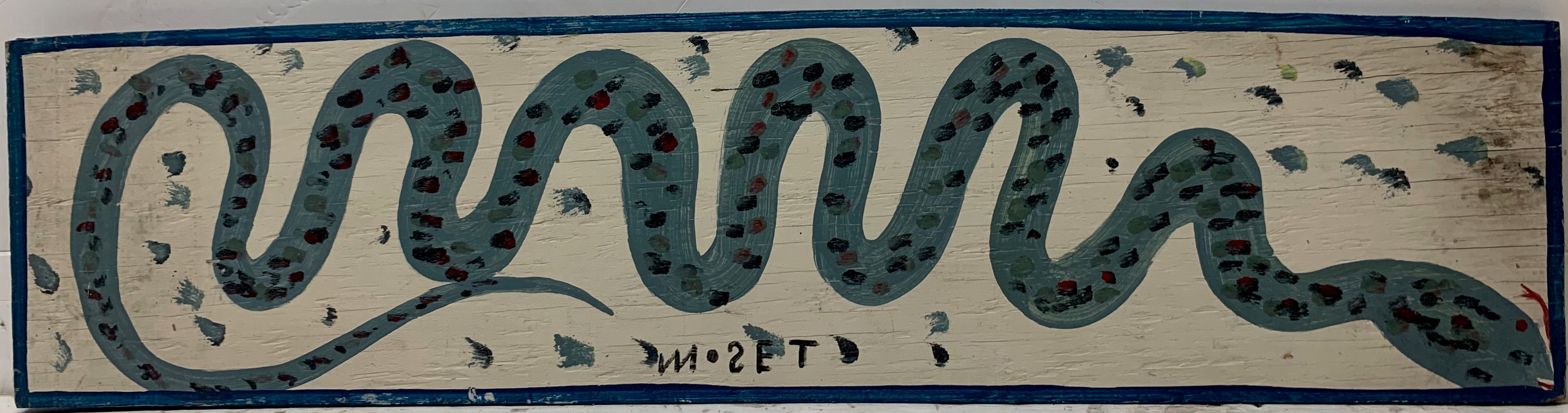 A Mose Tolliver painting of a twisting blue snake, speckled with scales of different shades of blue.