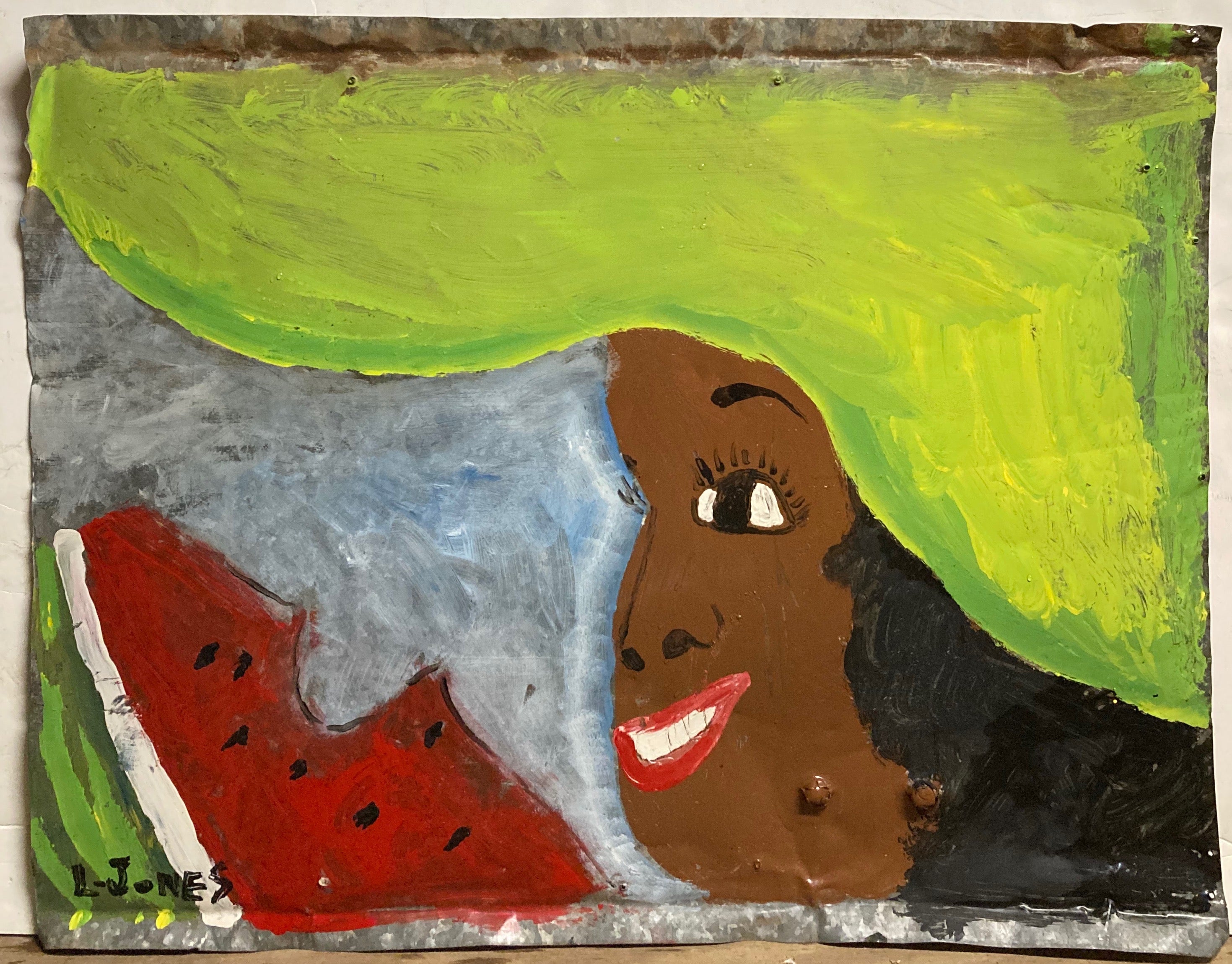 woman wearing big green hat eating a slice of watermellon