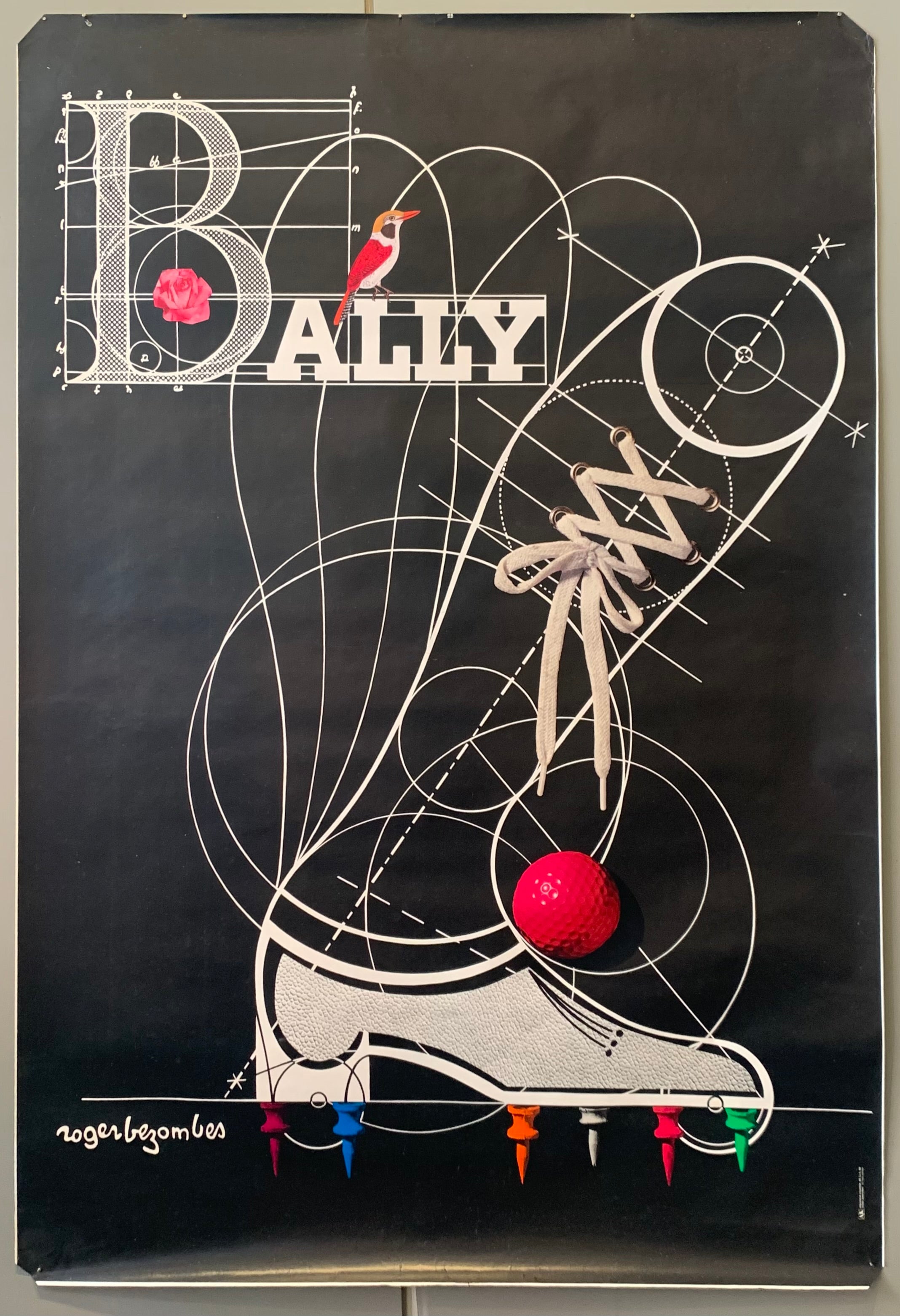 Black background, white sketch of a shoe comes out at all angles. A red golf ball sits on top and colored push pins are on the bottom. A bird and rose perch on the Bally logo.