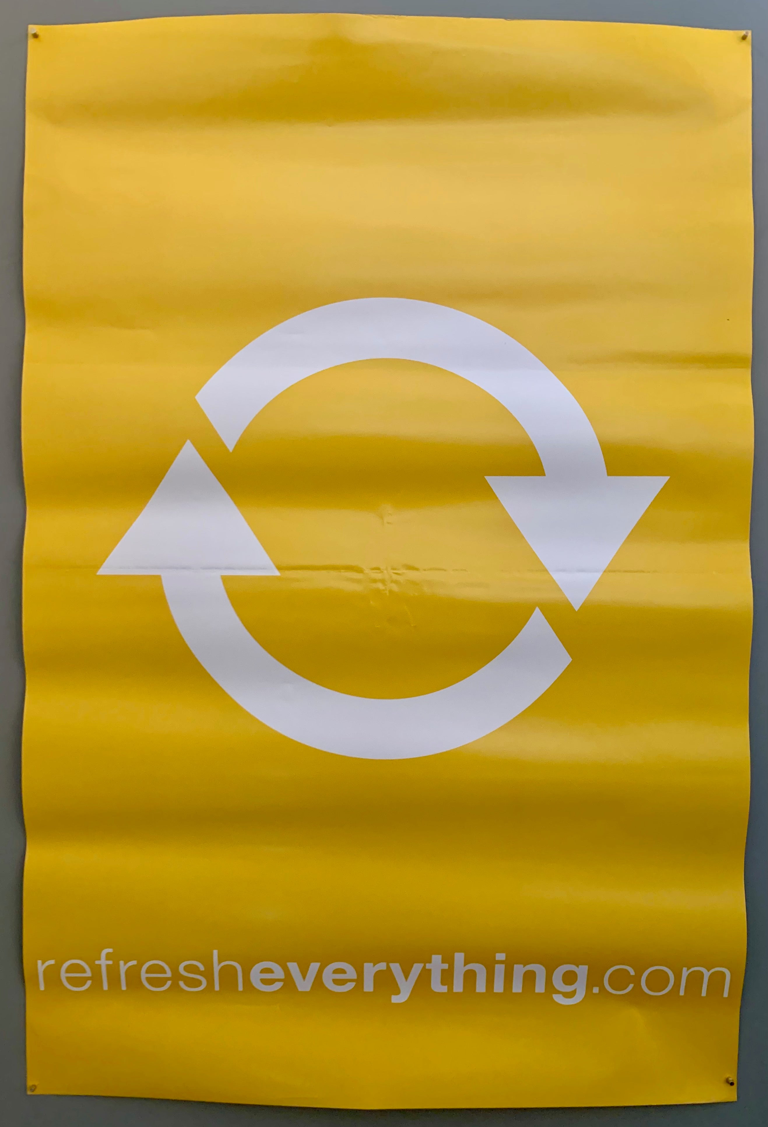 poster of a two white circular arrows on a yellow background