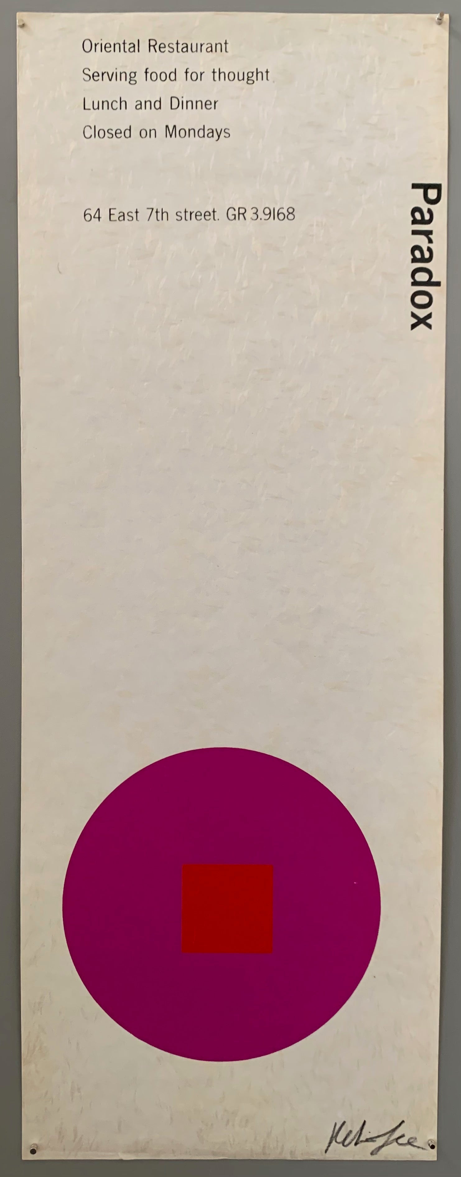 A purple circle with an red square on white paper.
