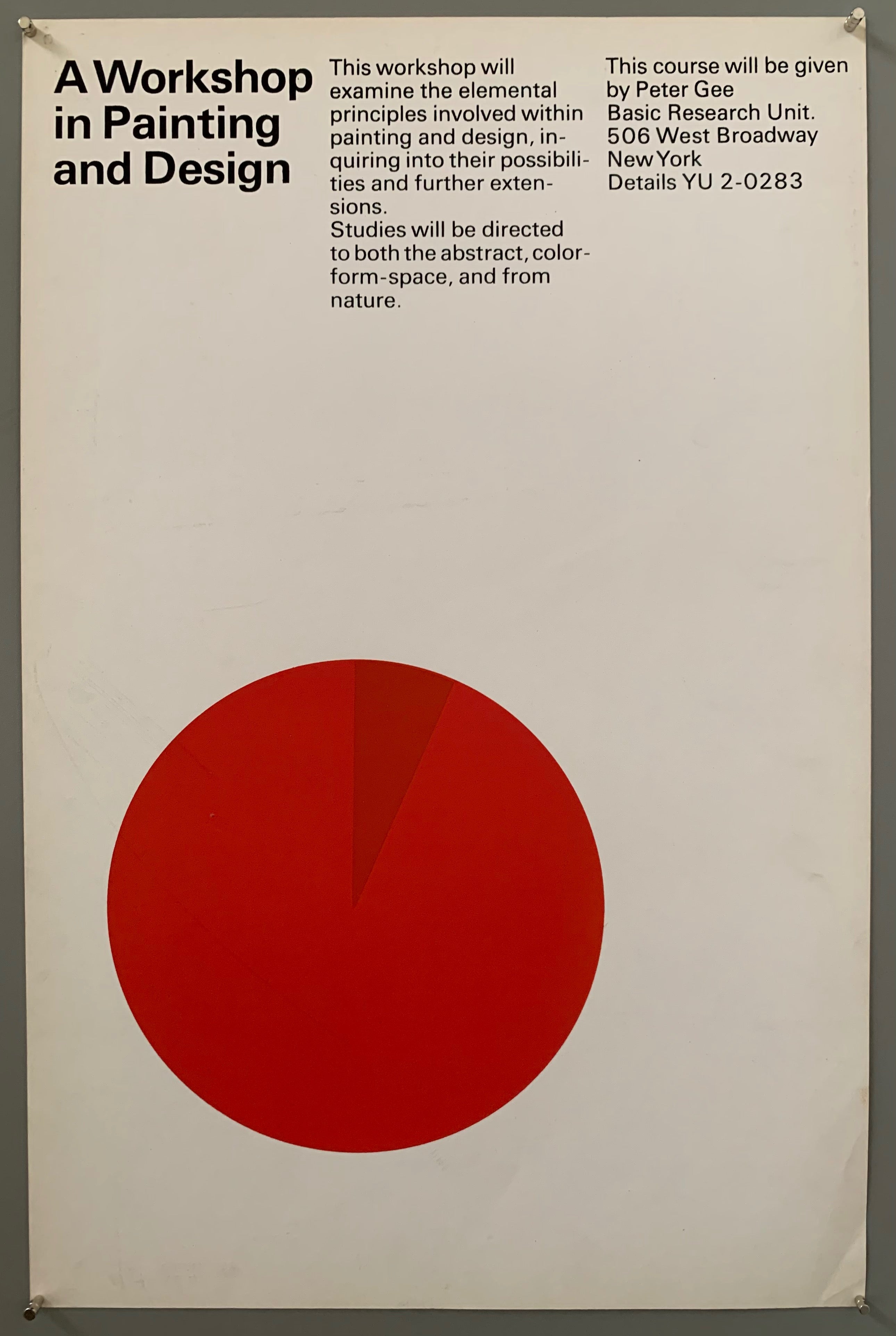 A plain sheet has a large circle with a tiny piece in a different color. The font is black and white. THe circle is red.