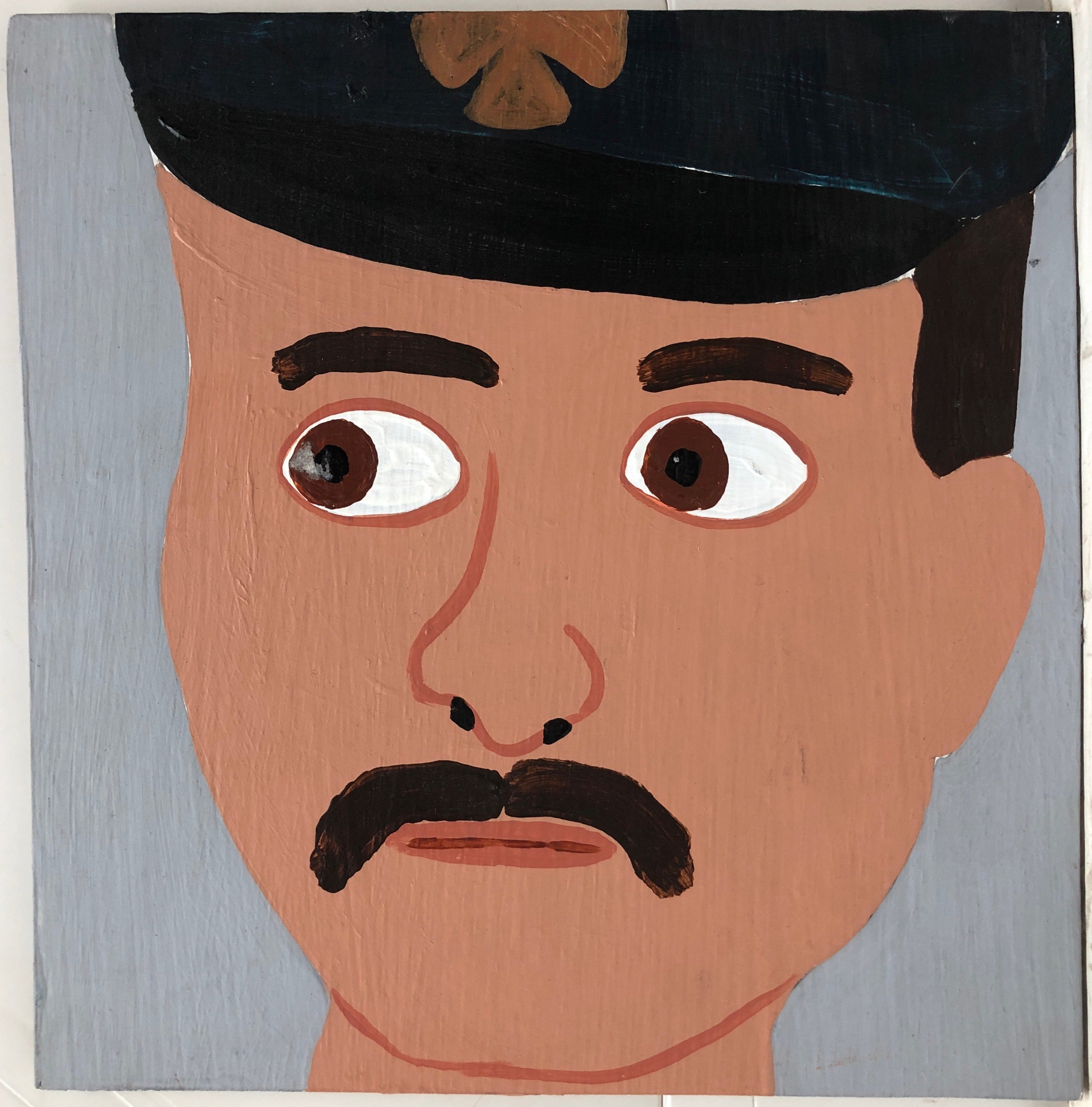 Portrait of Christopher Blackwell, moustached and in a black firefighter's hat.