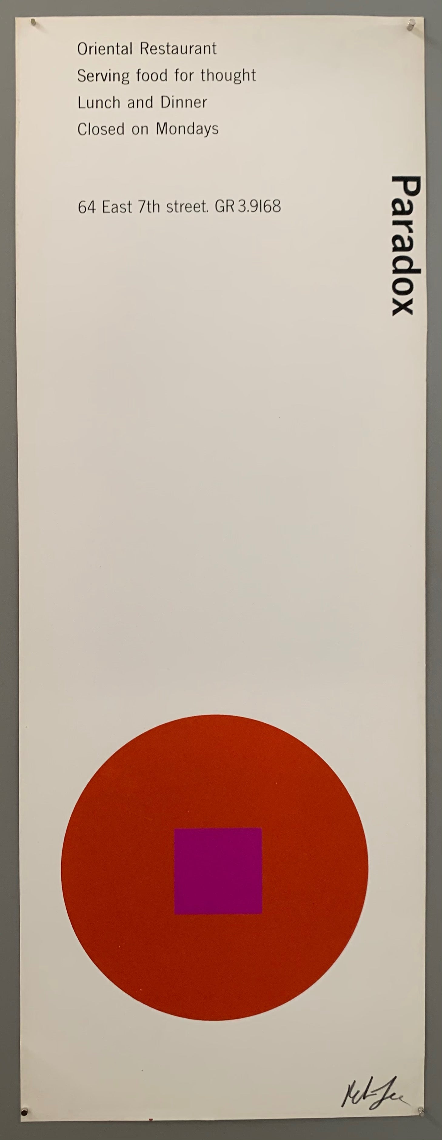A red circle with a purple square on white paper.