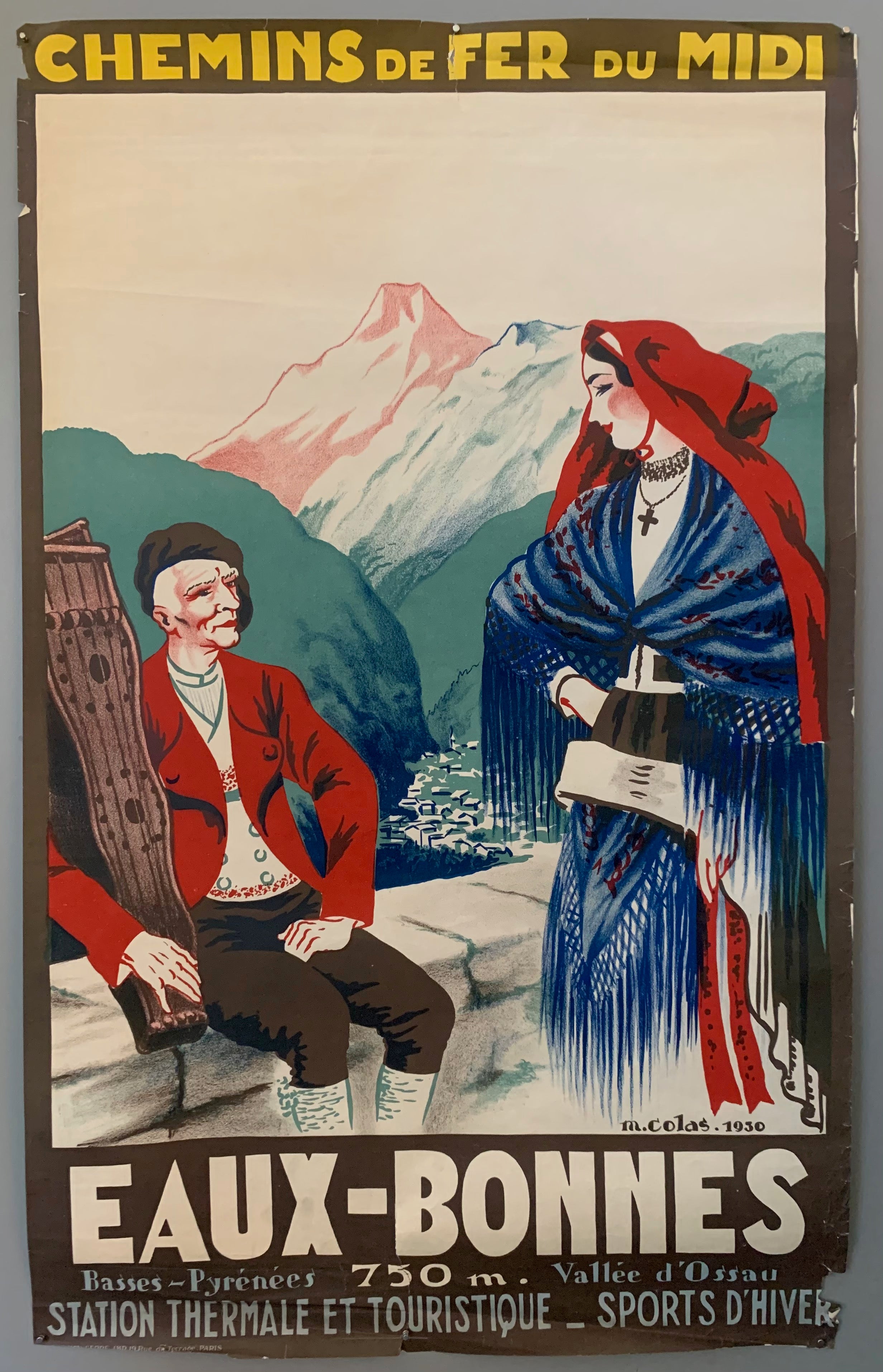 Two traditionally dressed residents sit on an overlook, the town nestled in the valley below. The mountain peaks stand out, matching the blue, red, and green color scheme of the rest of the poster. The border is a brown color with bold yellow, white, and grey writing. 