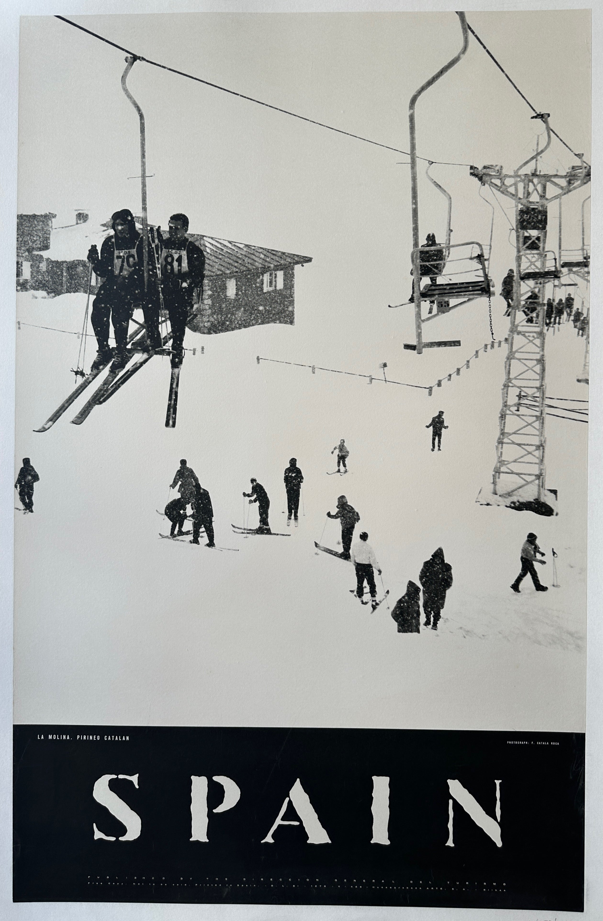 35x39.5 linen backed travel poster for Spain featuring a black and white photograph of people skiing