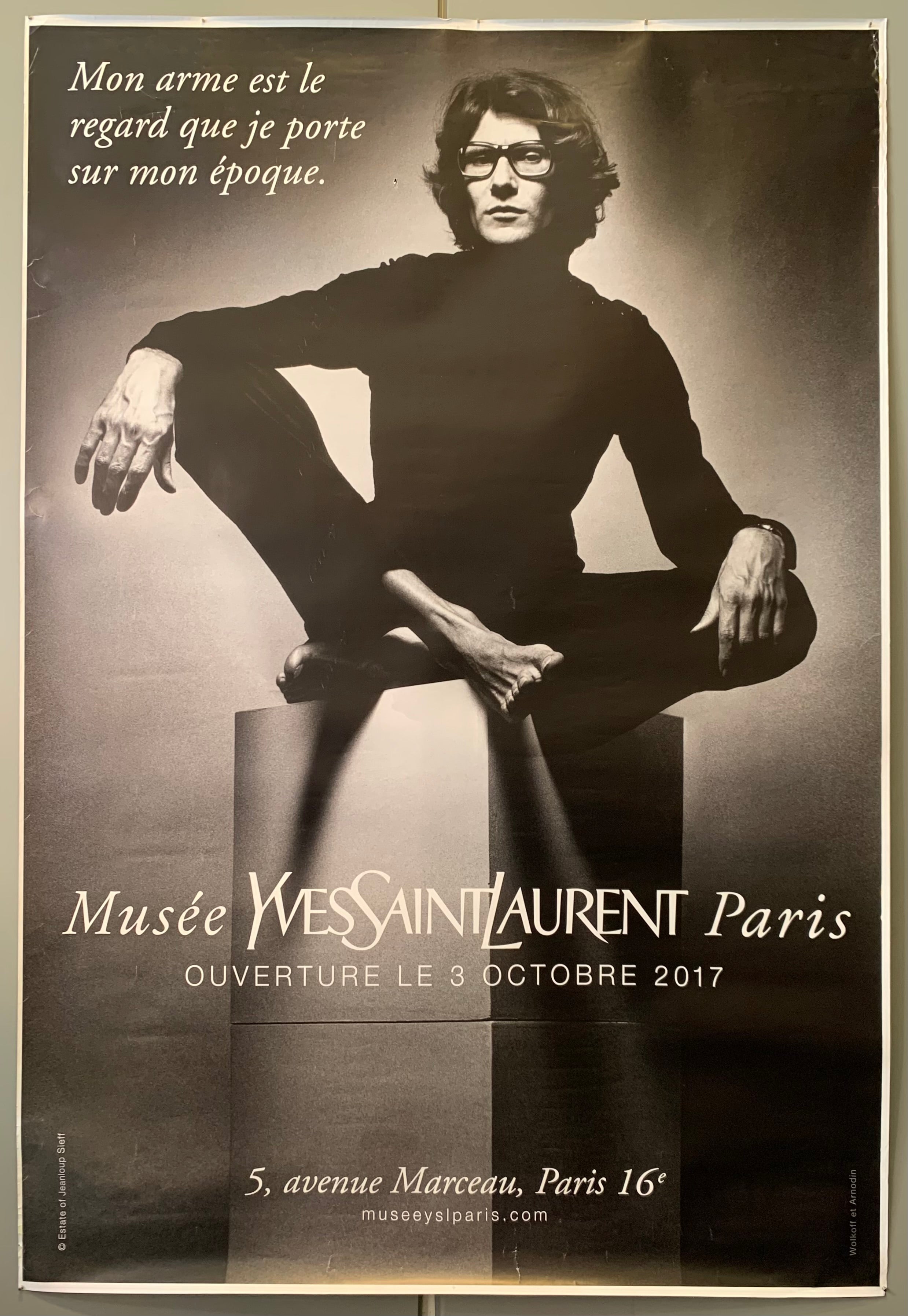 Photograph of YSL on a box. Black and white. Text is in white. 