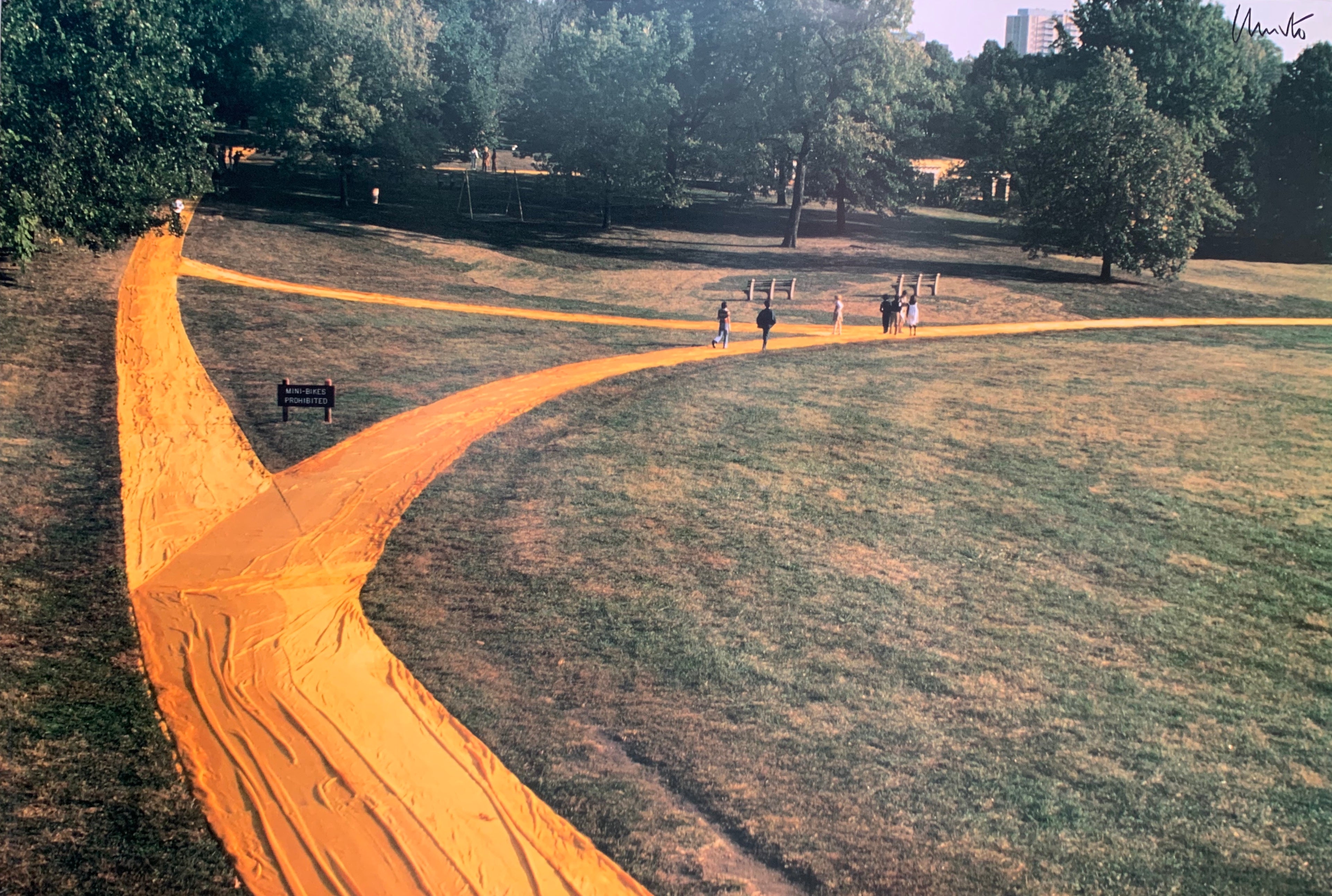Colored photograph with yellow forking path with children running on it. 