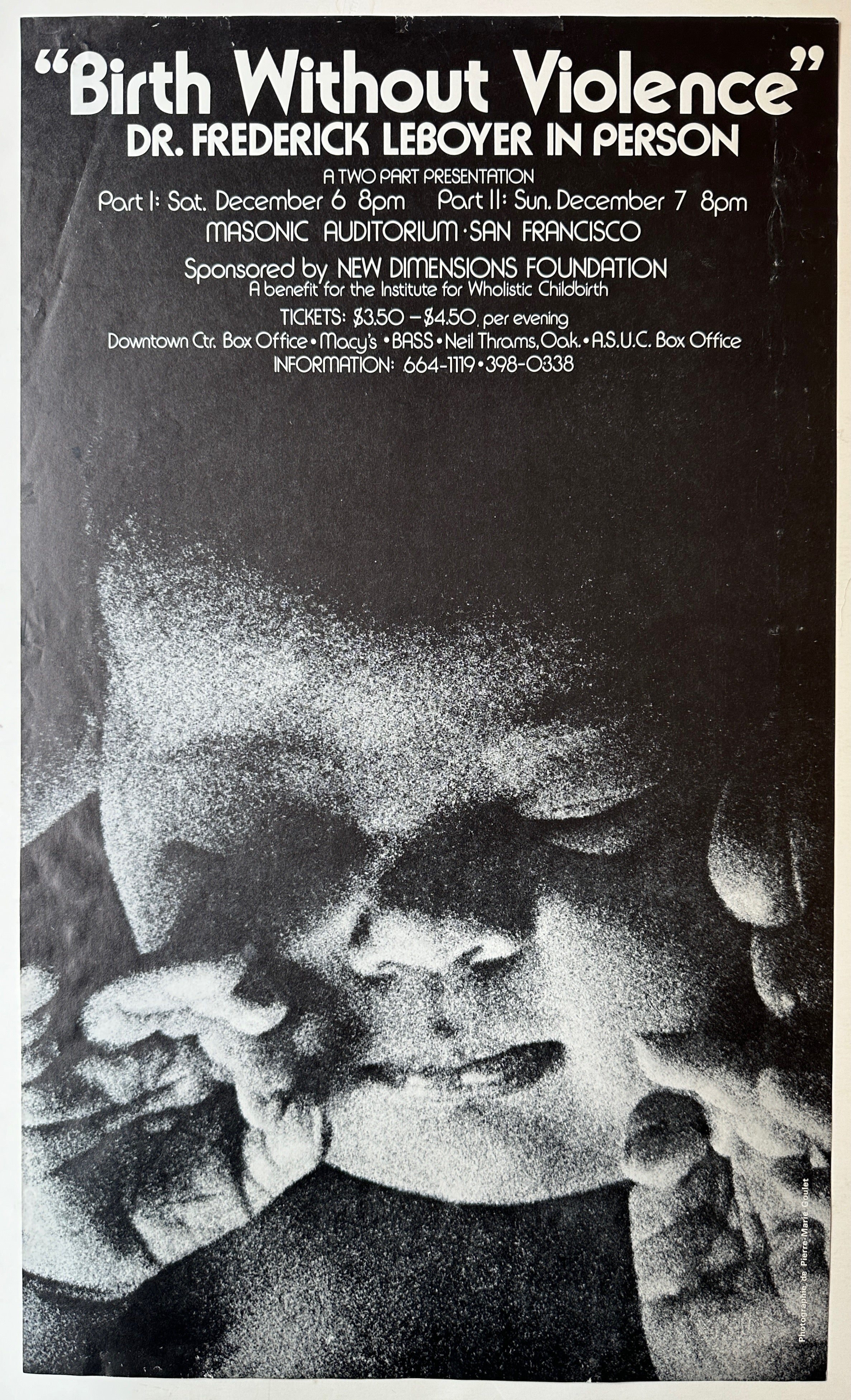 Black-and-white poster with white text and black background featuring a close-up of a baby's shaded face and hands.
